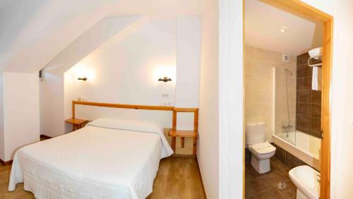 a bedroom with a white bed and a toilet at Hotel San Briz in A Pontenova