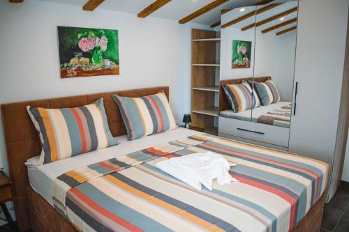 a bedroom with a bed with a shirt on it at Villa Angela in Orebić