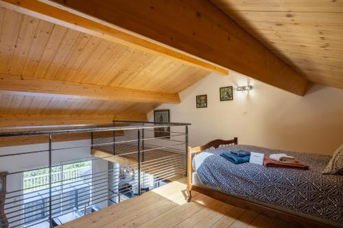 a bedroom with a bunk bed and a wooden ceiling at Maison Chalet in Le Nayrac