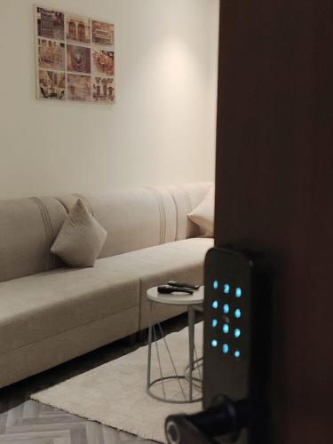 a living room with a couch and a table at Sukoon Apartment شقة سكون 2 in Buraydah