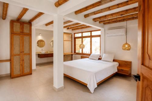 a bedroom with a white bed and a window at Boana hotel in Palomino