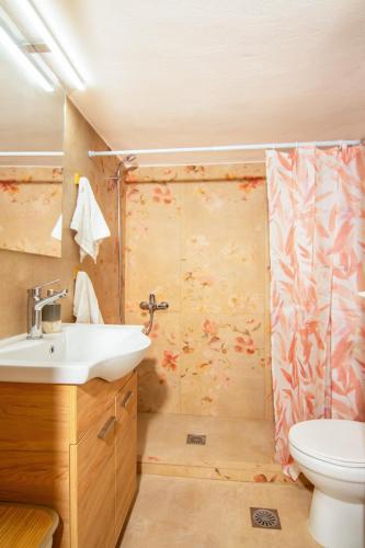 a bathroom with a sink and a shower at MC4 Residences in Loutraki