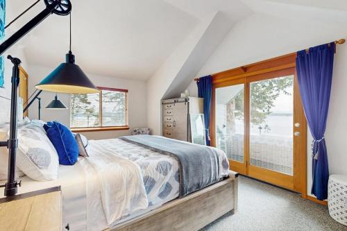 a bedroom with a bed and a large window at Breezy Point Retreat in Saratoga Shores
