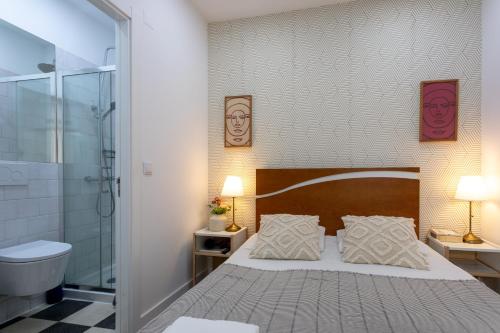 a bedroom with a large bed and a shower at Lisbon Poets Inn in Lisbon