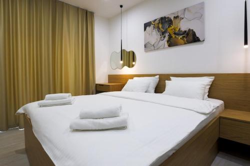 a bedroom with a large bed with white pillows on it at Villa Truman Klek in Klek