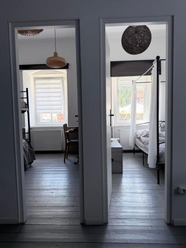 an open door to a bedroom with a bed at Sowa Loft in Zagórze Śląskie
