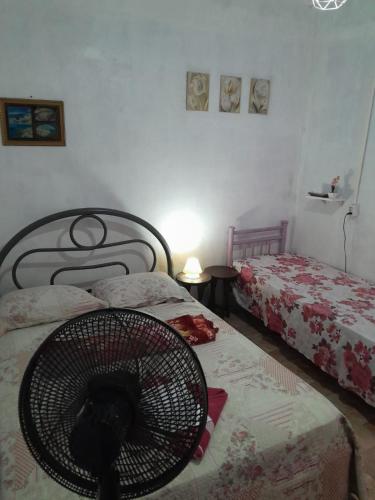 a bedroom with two beds and a cat in a fan at Hospedagem Chapéu Virado in Belém