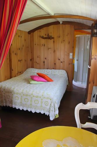 a bedroom with a bed with pink pillows on it at Chbres D'hôtes Ferme De Champliveau in Bonnée
