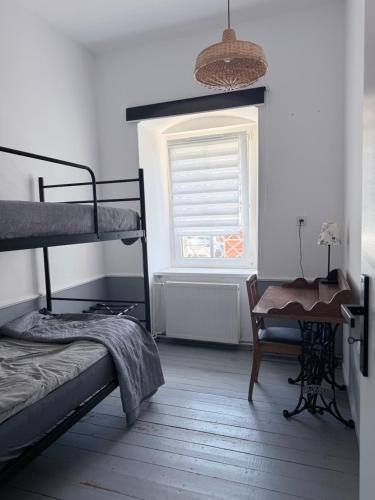 a bedroom with two bunk beds and a window at Sowa Loft in Zagórze Śląskie
