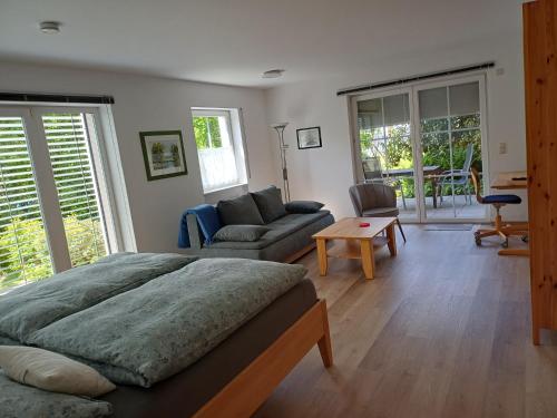 a bedroom with a bed and a living room at FeWo Fink in Regen