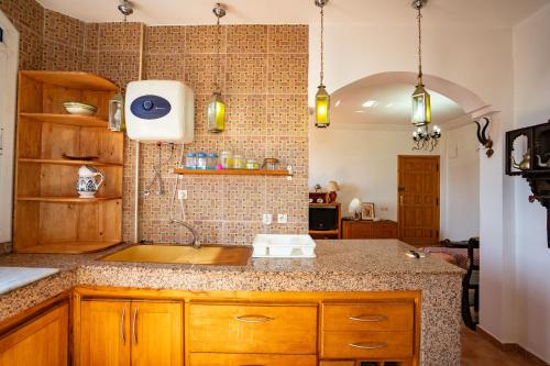 a kitchen with a sink and a counter at Get Salty Guesthouse in Tamraght Ouzdar
