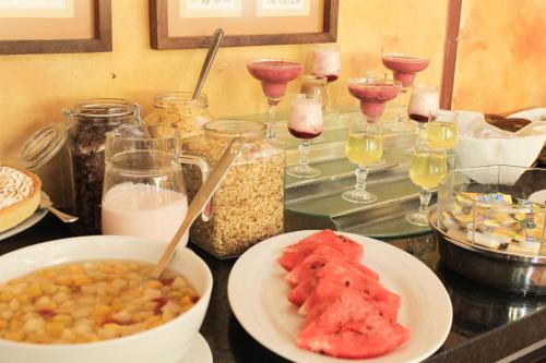 a table with bowls of food and glasses of wine at Hotel Leonardo da Vinci in Santiago