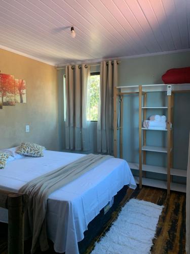a bedroom with a large bed with a white bedspread at Casa mussambé in Sao Jorge