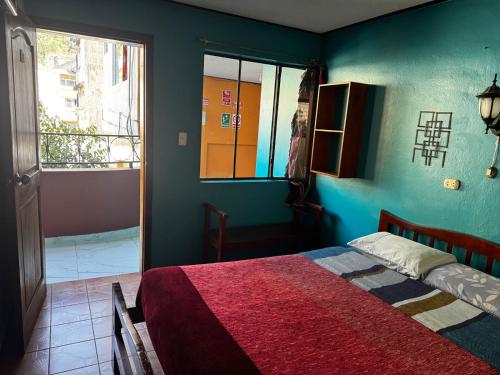 a bedroom with a bed and a large window at Transilvania in Baños