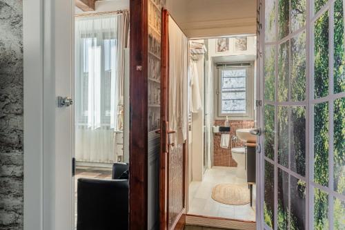 a bathroom with a door open to a bathroom with a toilet at Villa Mon Paradis in Lucca