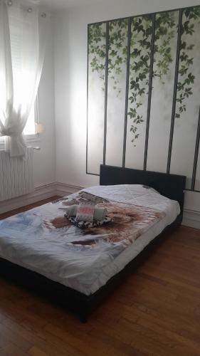 a large bed in a room with at Maison Conviviale amiens in Amiens