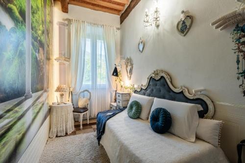 a bedroom with a bed with blue and white pillows at Villa Mon Paradis in Lucca