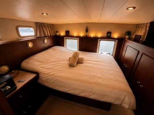 a bedroom with a large bed in a boat at Zimon- Bateau Authentique - vue sur la Seine in Rouen