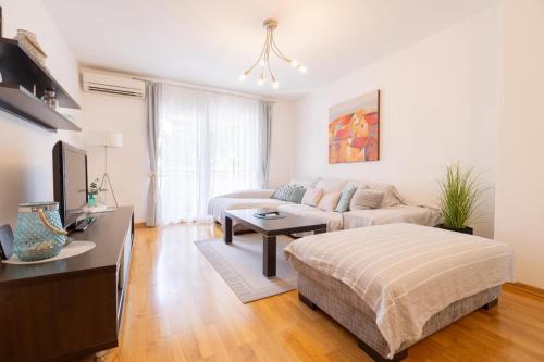 a living room with a couch and a table at Sea & Sky Retreat in Makarska