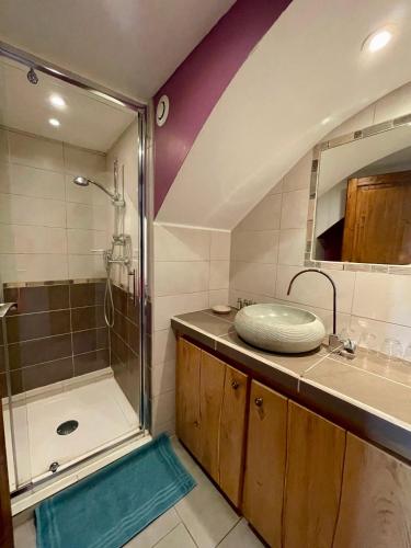 a bathroom with a shower and a sink and a tub at Les Dolines in Balazuc