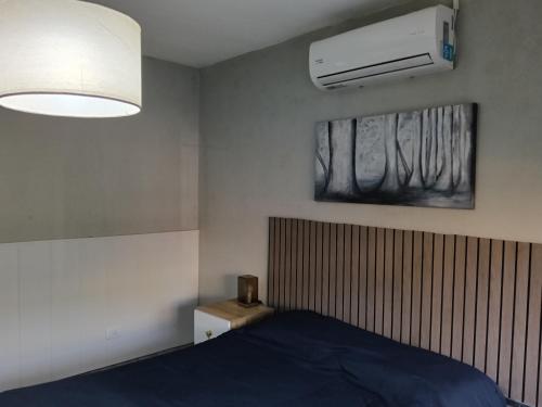 a bedroom with a bed and a air conditioner at Dto III Temperley in Temperley