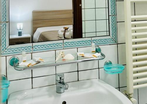a bathroom with a sink and a mirror and a bed at View Ischia & Procida -Villa Lamberti Casa Panorama in Monte di Procida