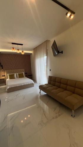 a bedroom with a bed and a couch in a room at Studios Periklis in Limenas