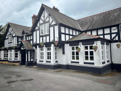 a row of black and white buildings with flower pots at Egerton Arms in Chester