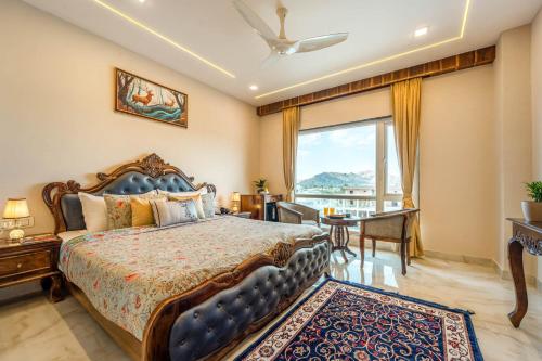 a bedroom with a bed and a large window at Mangal Residency in Bedla