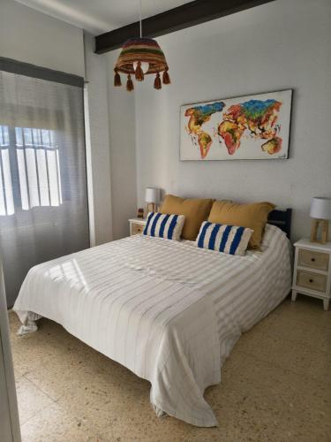 a bedroom with a large bed with a map on the wall at Eco- Refugio Centenario in Sagunto