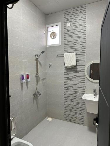 a bathroom with a shower and a sink at Reef Sinaw Apartments in Sinaw