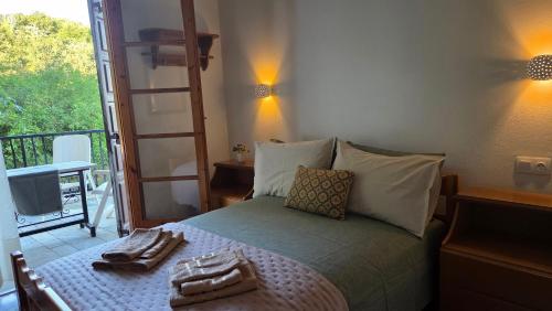 a bedroom with a bed with a view of a balcony at Holiday Home Neochori Pelion in Neochori