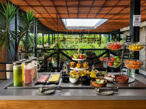 a buffet with many different types of food on a table at The Art Hotel El Poblado Medellín By Key 33 in Medellín