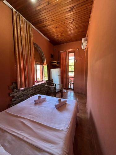 a bedroom with a bed with two towels on it at Bach-Ana in Ureki