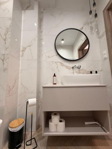a bathroom with a sink and a mirror at Apartament 15 in Lębork