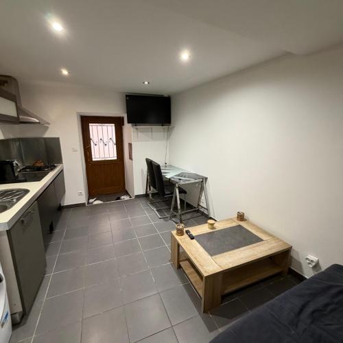 a kitchen with a table in the middle of a room at Appartement centre ville in Ajaccio