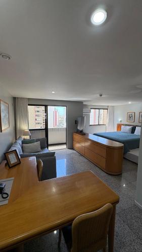 a living room with a couch and a bed and a table at 1506 - Blue Tree Towers in Fortaleza