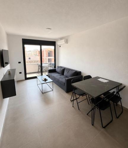 a living room with a couch and a table at Apartments Lialda in Donji Štoj