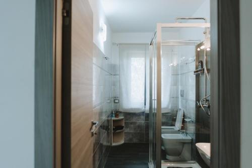 a bathroom with two sinks and a toilet and a mirror at Aura Residence in San Biagio
