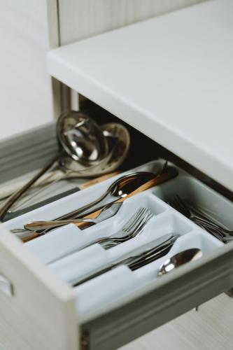 a drawer filled with silver utensils in a kitchen at Aura Residence in San Biagio