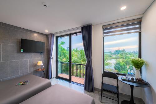 a hotel room with a bed and a large window at Kikihao Homestay Hội An Near Tra Que Village in Hoi An