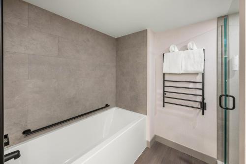 a bathroom with a tub and a shower stall at Royal Canadian Lodge in Banff