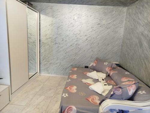 a small bedroom with a bed withpillows on it at Studio Denisa in Călan