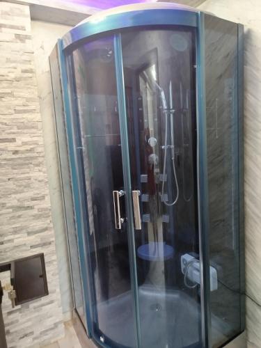 a glass shower in a bathroom with two toilets at Studio Denisa in Călan