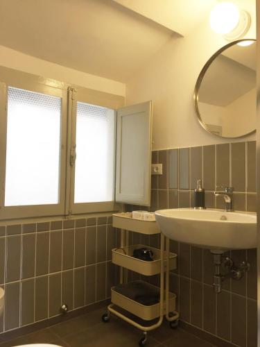 a bathroom with a sink and a mirror at Loft with a ducal view in Urbino