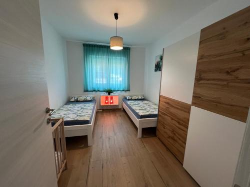 a room with two beds and a window at Apartment CReO Loborika in Marčana