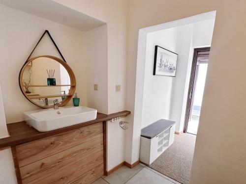 a bathroom with a sink and a mirror at Up Residences S in Baden