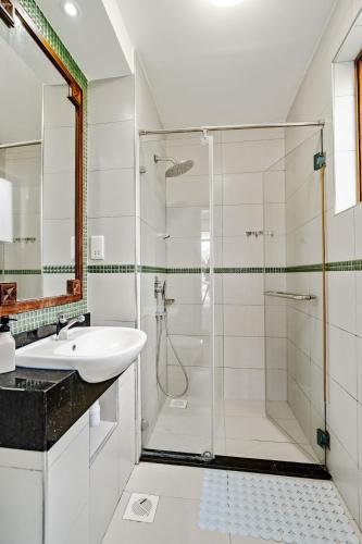 a bathroom with a glass shower and a sink at Binti House- Sultan Palace in Mombasa
