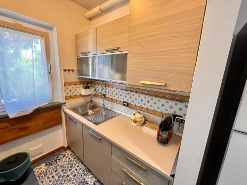 a kitchen with a sink and a counter top at Villa I Giardini del Conero con ombrellone in spiaggia in Porto Recanati