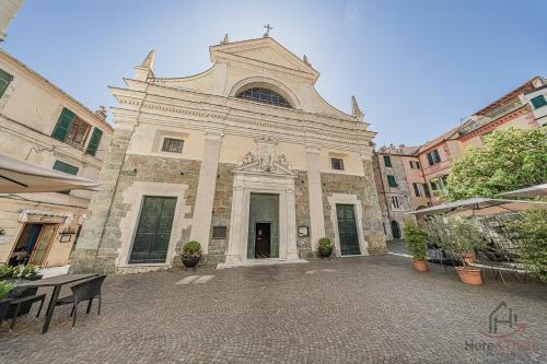 a large stone building with a cross on the front at Behind the Sea - Parcheggio gratis - mare 5 min in Noli
